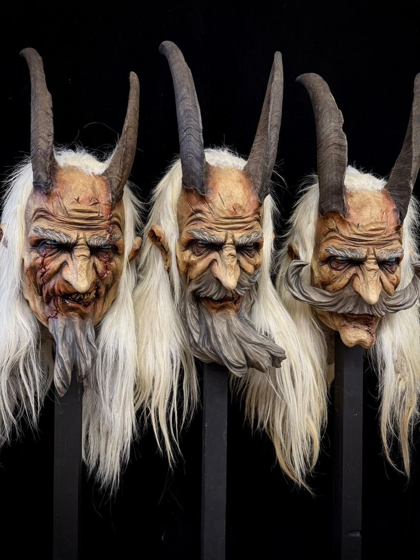 Drei Krampusmasken mit langen weißen Bärten